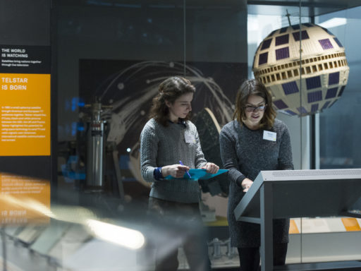 Two visitors read an interpretation of an object at the Science Museum Gallery, London.