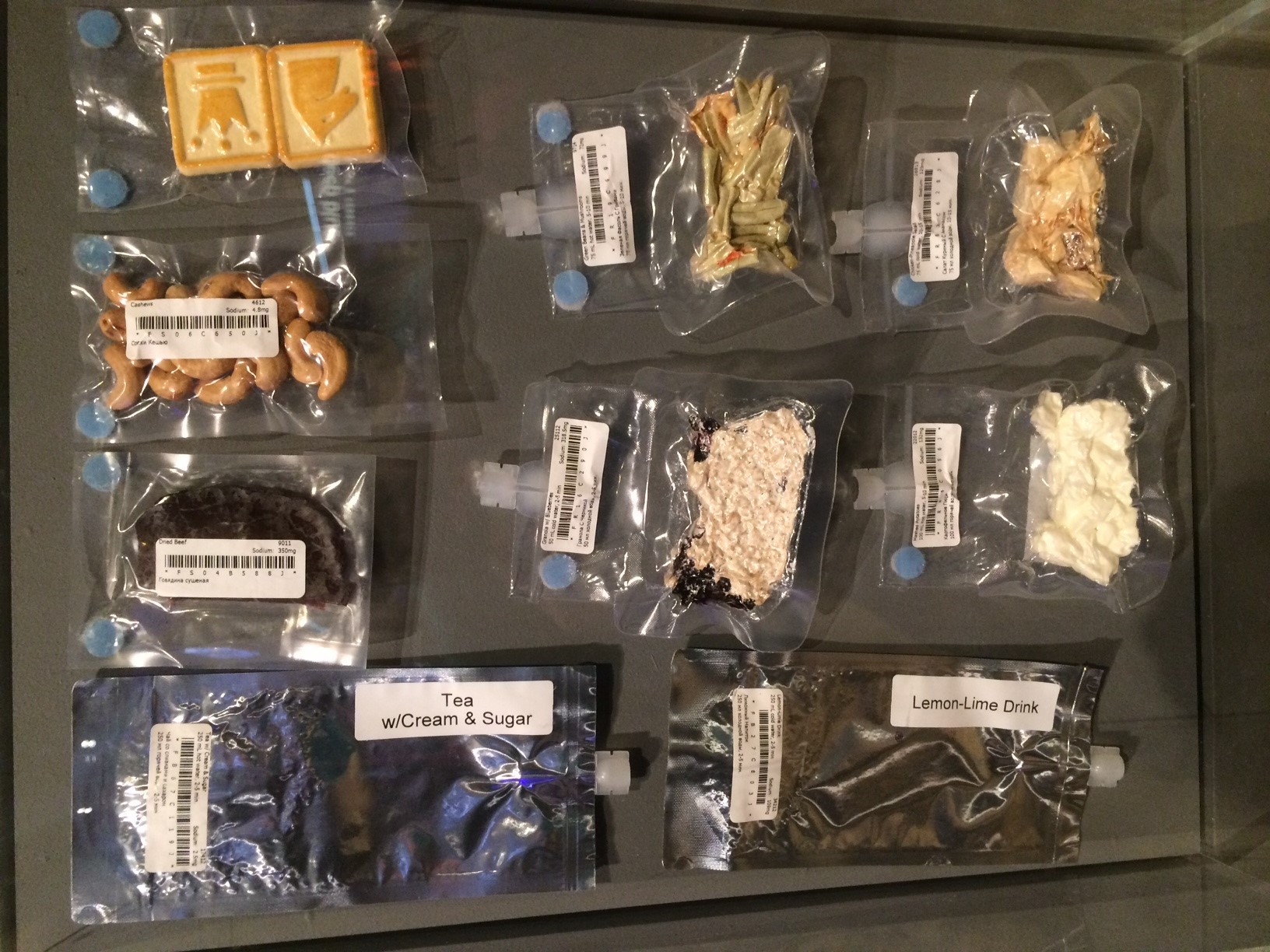 Vacuum-packed portions of food, drink and snacks that astronauts eat in space are laid out on a table.