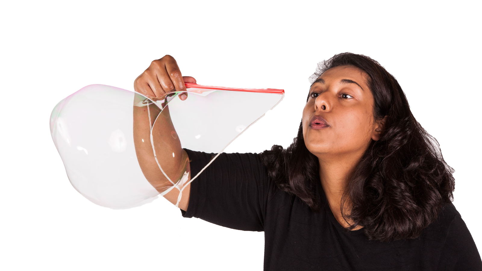Photograph of someone blowing a giant bubble.