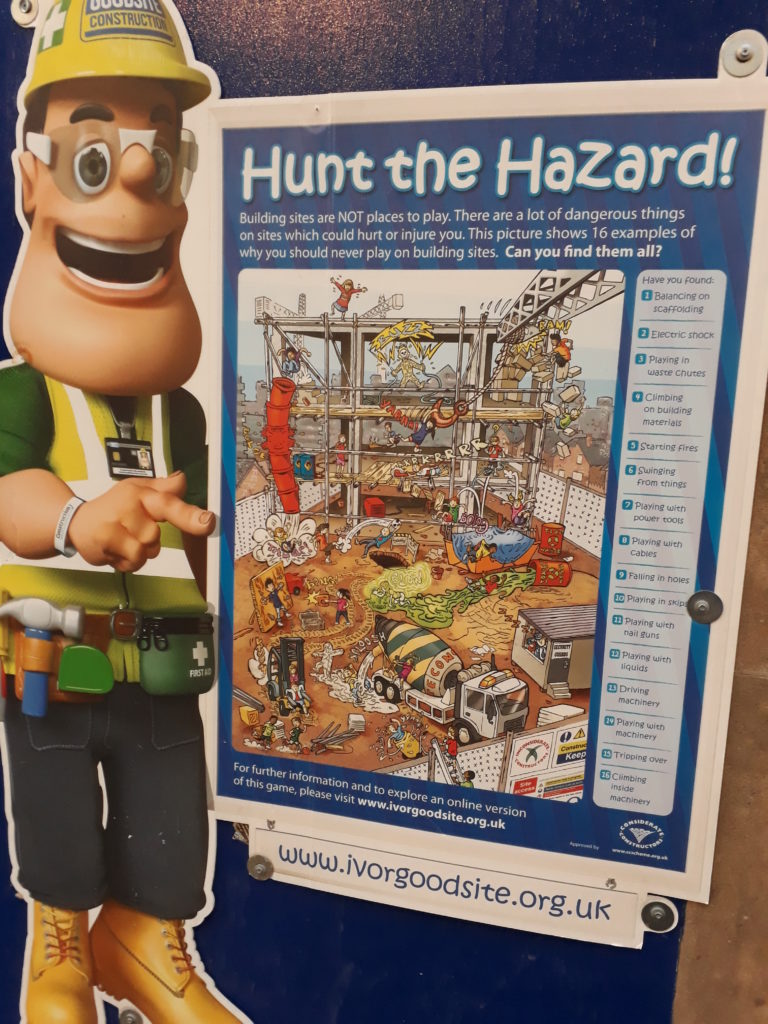 Hunt the Hazard poster for people to find hazards on a dangerous cartoon building site.