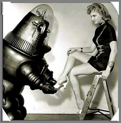 Vintage black and white photograph of a metal robot, slipping a white shoe on to the foot of a blonde model