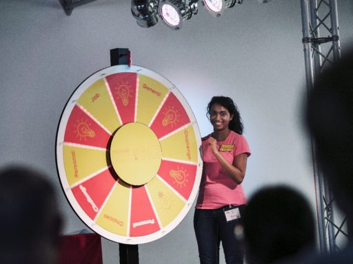 A presenter spinning the Engineer Like Me gameshow wheel.