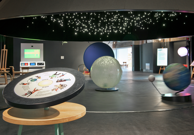 The orbits exhibit, giant model of the solar system that people can ride on.