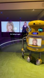 Robot with screen displaying image of girl visitor.