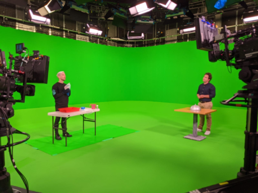 Maxwell Hamilton being filmed in front of a green screen demoing one of our hands-on activities with Sam Nixon in the BBC studios.
